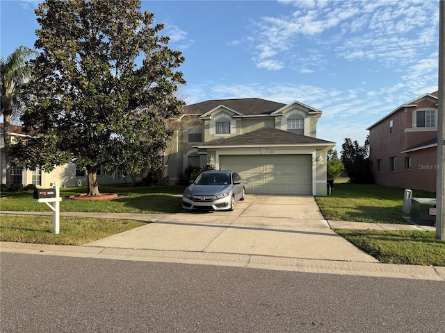 traditional-style home featuring driveway, an attached garage, and a front yard