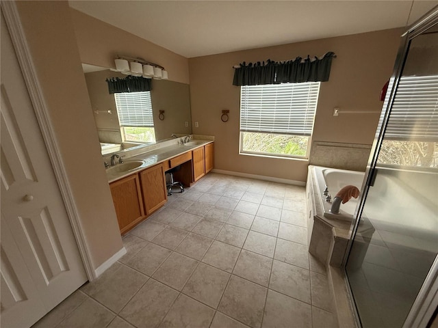 full bath with double vanity, a garden tub, a sink, and tile patterned floors