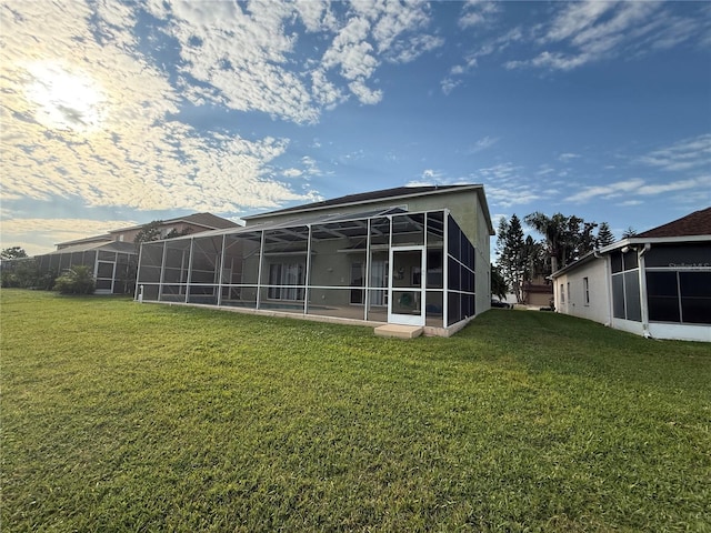 rear view of property featuring a yard