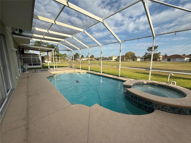 view of swimming pool with glass enclosure, a pool with connected hot tub, a yard, and a patio