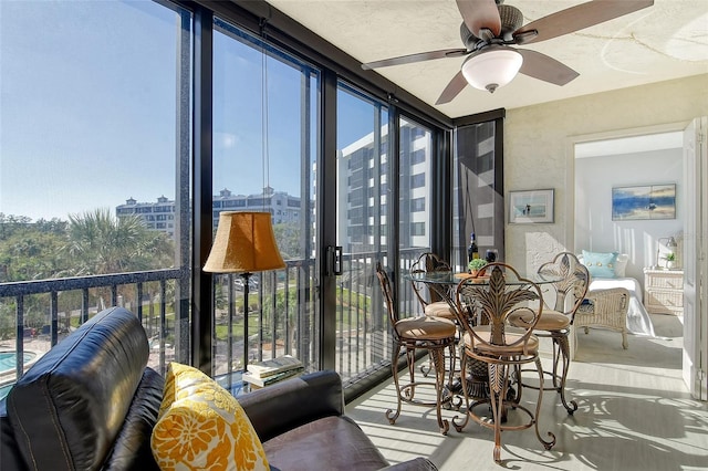 sunroom / solarium with plenty of natural light and a city view