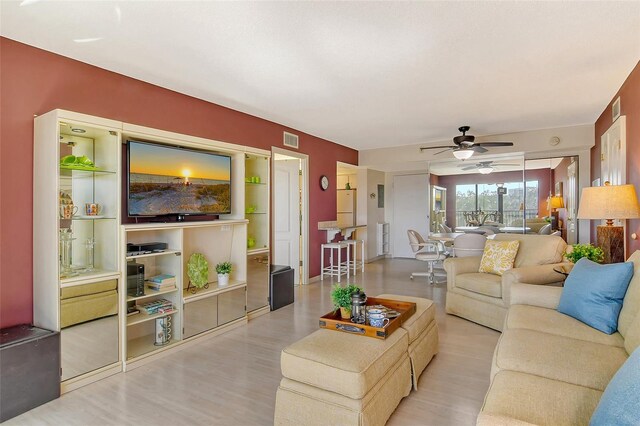 living area featuring ceiling fan and light wood-type flooring
