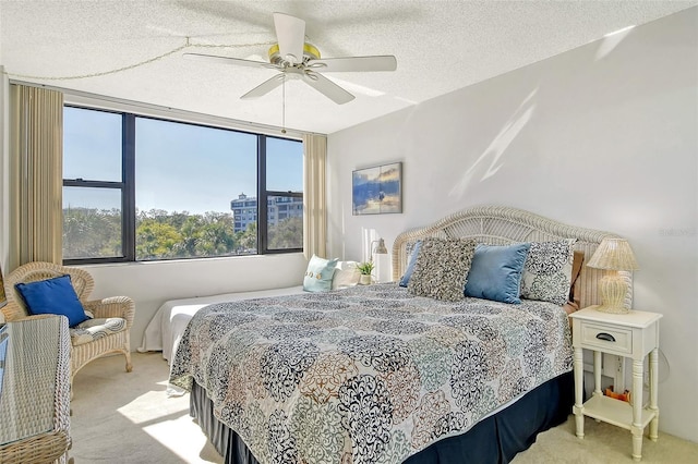 carpeted bedroom with a textured ceiling and ceiling fan