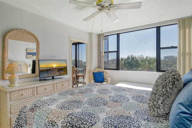 bedroom featuring a textured ceiling and a ceiling fan