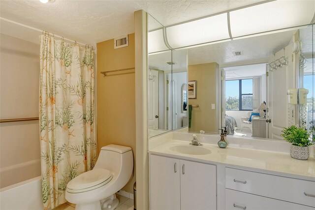 ensuite bathroom with toilet, vanity, shower / bath combination with curtain, and a textured ceiling