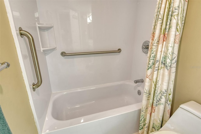 bathroom with shower / bath combo and toilet
