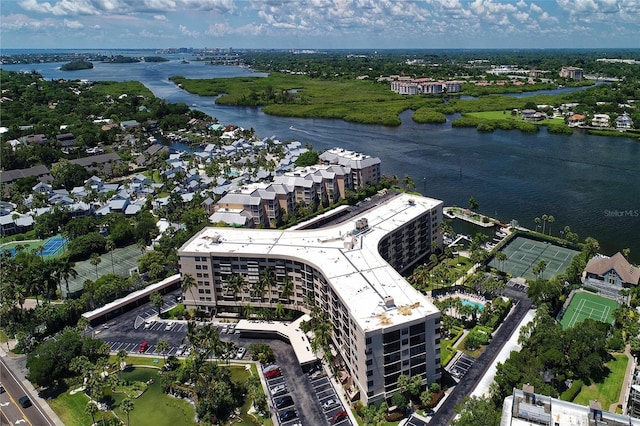 drone / aerial view of a large body of water and apartment complex / building