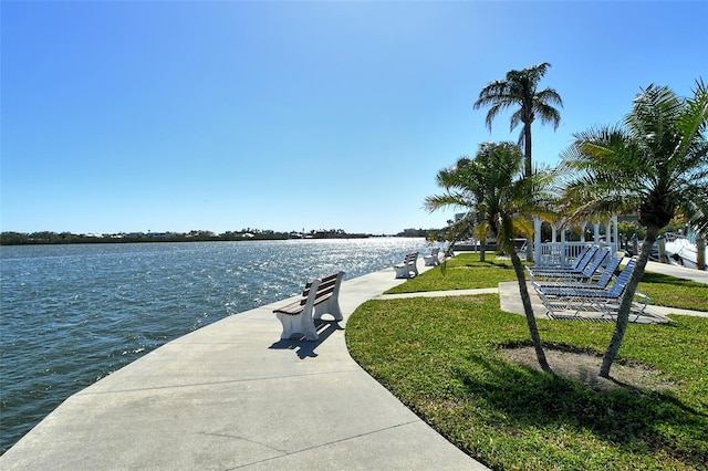view of community with a water view and a lawn