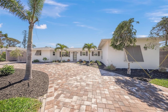 ranch-style house featuring stucco siding