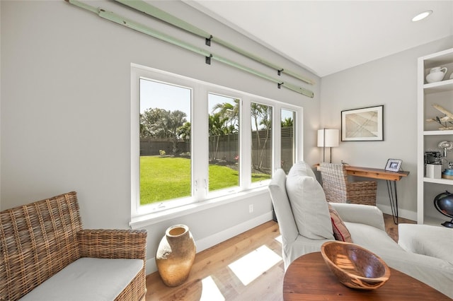 living area featuring recessed lighting, wood finished floors, and baseboards