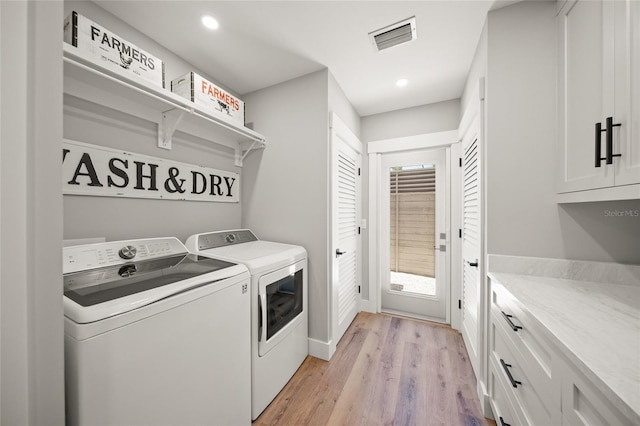 clothes washing area with visible vents, recessed lighting, cabinet space, separate washer and dryer, and light wood finished floors