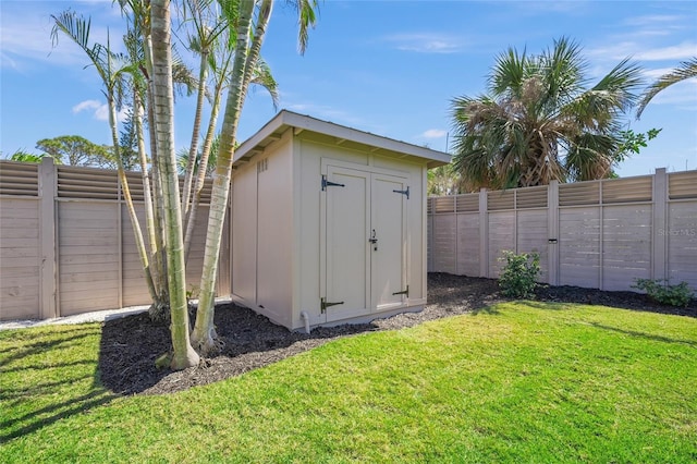 view of shed with a fenced backyard