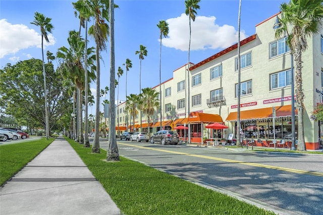 view of street with sidewalks, curbs, and street lights