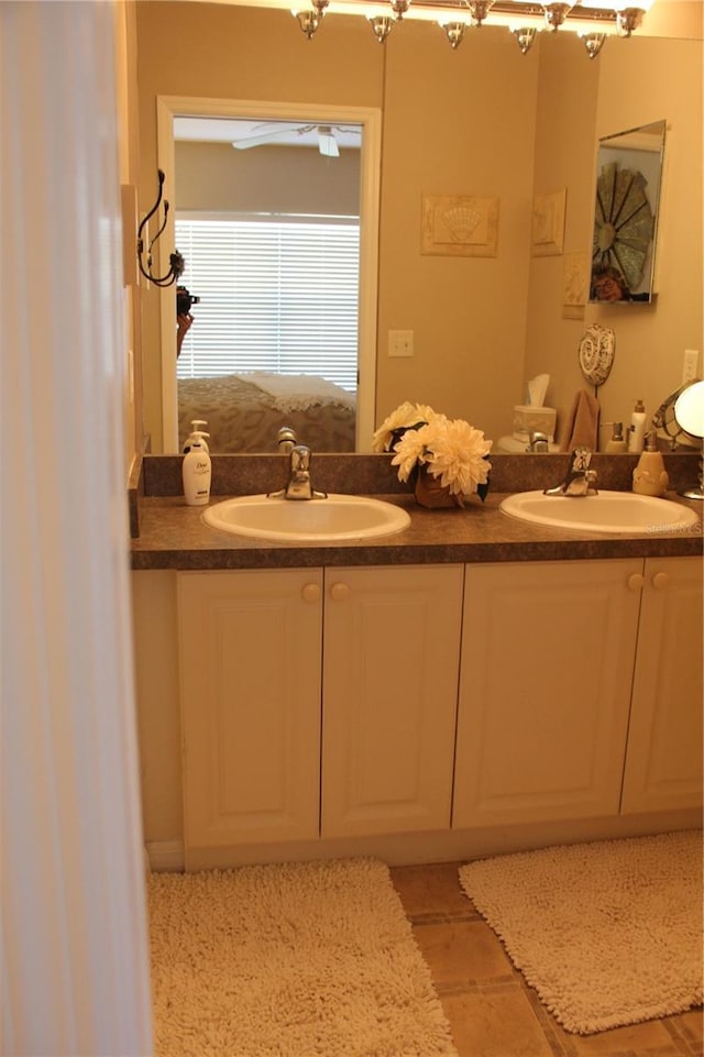 bathroom featuring a sink and double vanity