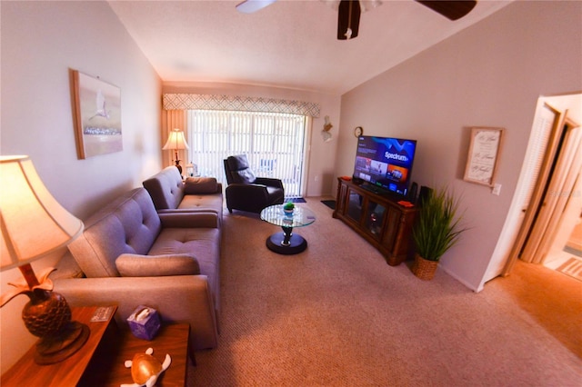 living area featuring lofted ceiling, ceiling fan, and carpet flooring