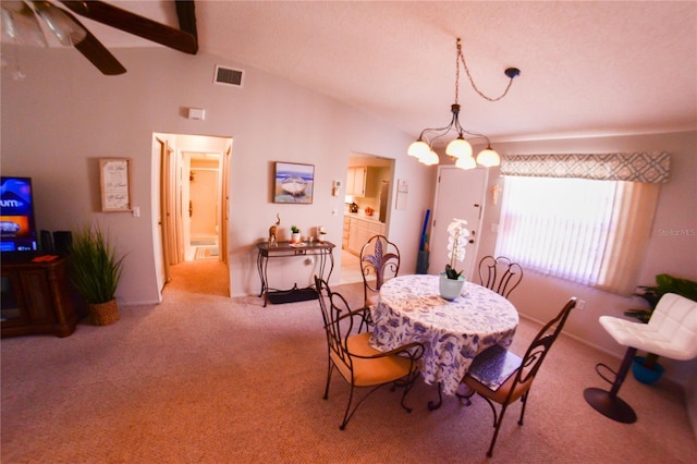 dining room featuring lofted ceiling with beams, carpet flooring, visible vents, and ceiling fan