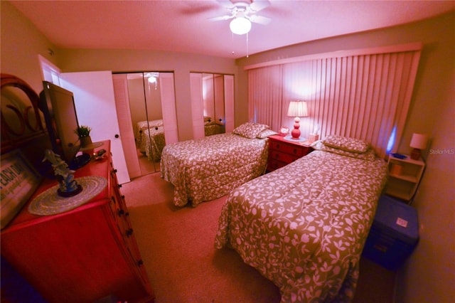 carpeted bedroom featuring two closets and ceiling fan