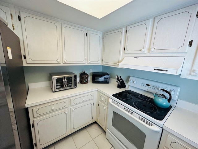 1412 56th St W Unit 1412, Bradenton, FL 34209 - kitchen featuring freestanding refrigerator, white cabinetry, exhaust hood, electric stove, and light countertops