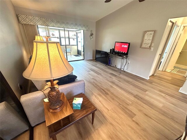 1412 56th St W Unit 1412, Bradenton, FL 34209 - living room with lofted ceiling, baseboards, and wood finished floors