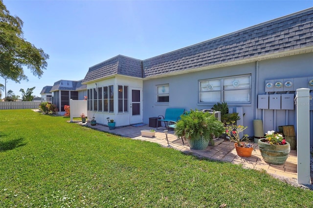 3807 41st Street Ct W Unit 52, Bradenton, FL 34205 - rear view of house with stucco siding, roof with shingles, a patio, mansard roof, and a lawn