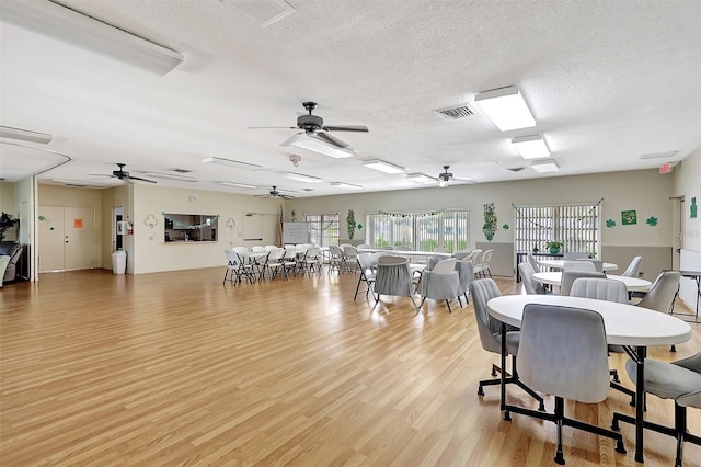 3807 41st Street Ct W Unit 52, Bradenton, FL 34205 - dining room with light wood-type flooring, a ceiling fan, a textured ceiling, and visible vents