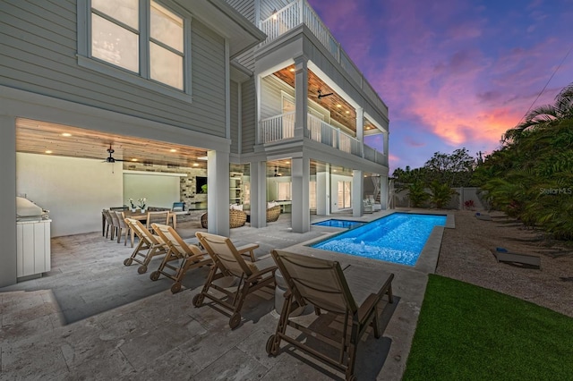 outdoor pool with outdoor dining space, a patio area, a fenced backyard, and ceiling fan