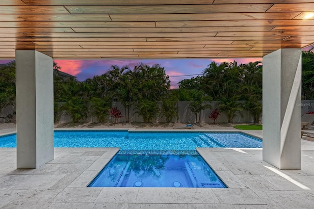 view of swimming pool with a patio area, a fenced backyard, and a pool with connected hot tub