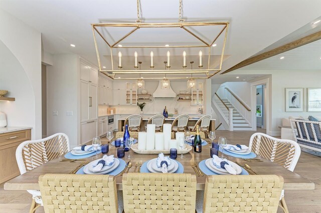 dining area featuring a chandelier, stairway, light wood-style flooring, and recessed lighting