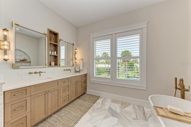 full bathroom featuring a soaking tub, double vanity, baseboards, and a sink