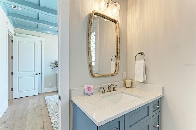 bathroom with visible vents, wood finished floors, and vanity