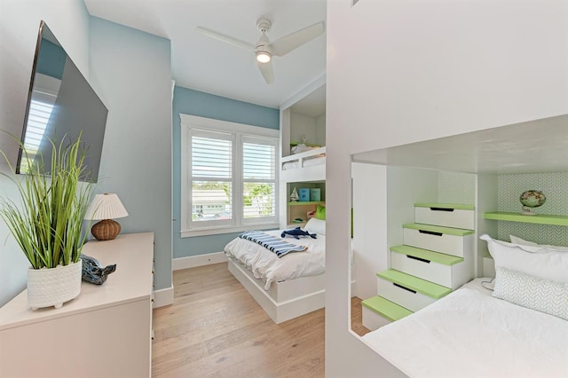 bedroom with baseboards, light wood-style floors, and a ceiling fan