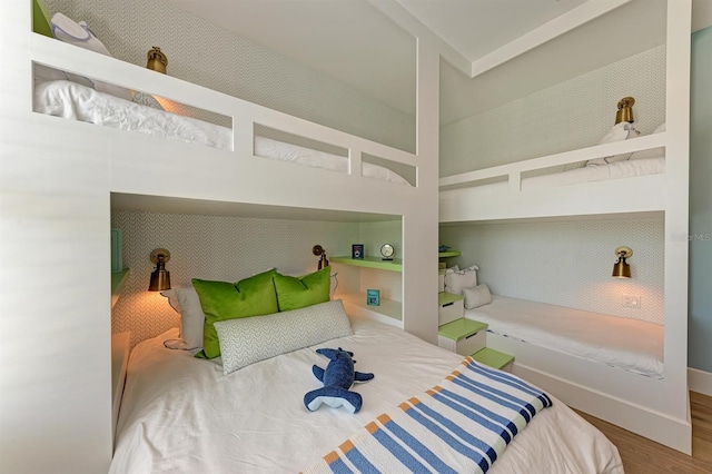 bedroom with baseboards and wood finished floors