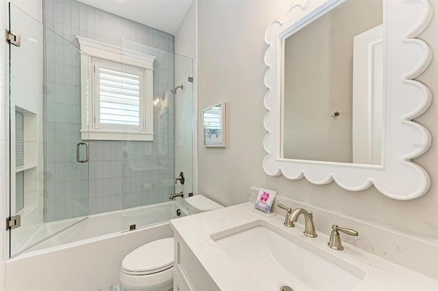 full bath featuring vanity, toilet, and enclosed tub / shower combo