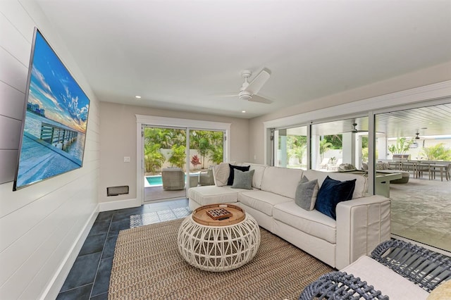 living area with recessed lighting, baseboards, ceiling fan, and a sunroom