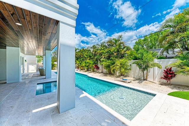 view of swimming pool with a fenced in pool, a fenced backyard, and a patio area