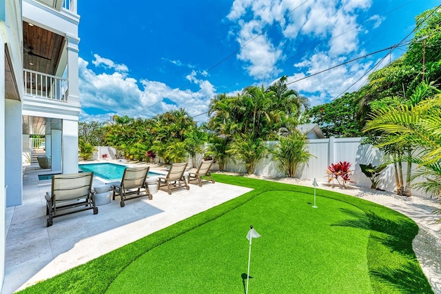 view of yard featuring a patio area, a fenced in pool, and a fenced backyard