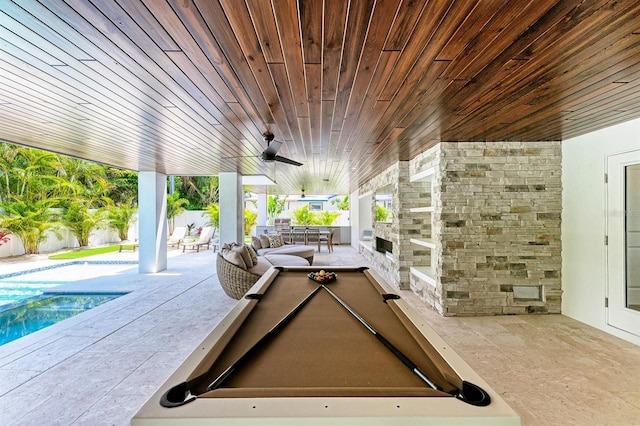 view of patio featuring an outdoor pool, outdoor dining space, a ceiling fan, and fence