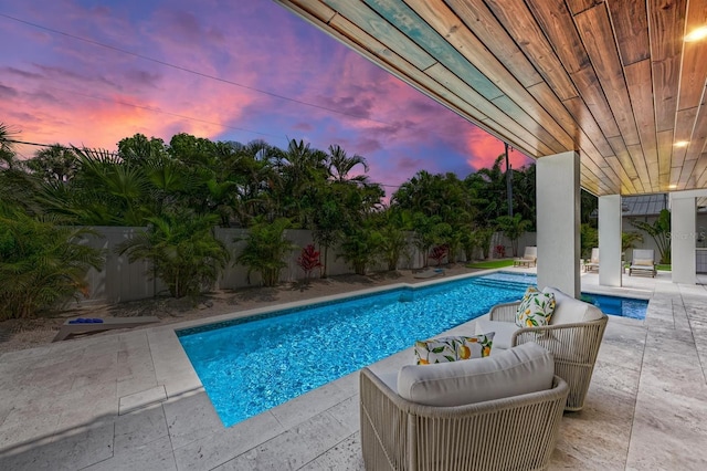 pool featuring a patio and a fenced backyard