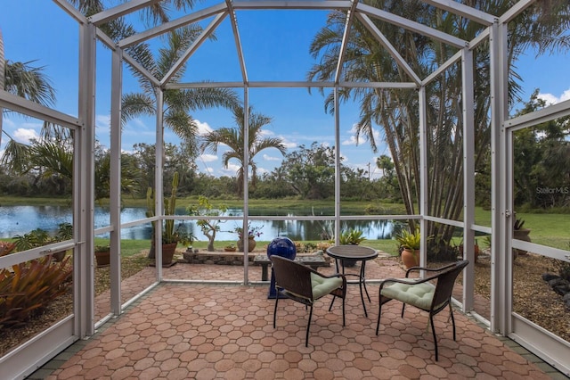 unfurnished sunroom featuring a water view and plenty of natural light