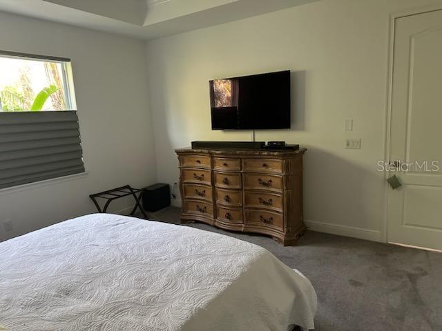 bedroom with carpet and baseboards