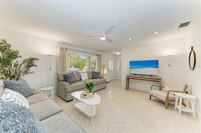 living area featuring visible vents, baseboards, ceiling fan, speckled floor, and recessed lighting