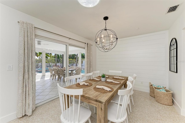 dining space featuring baseboards, visible vents, and a chandelier