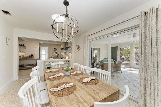 dining area featuring baseboards, visible vents, and an inviting chandelier