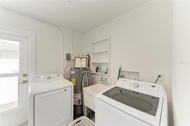 laundry area with laundry area, ornamental molding, washer and clothes dryer, and plenty of natural light