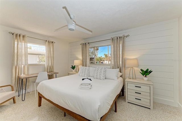 bedroom featuring a ceiling fan and multiple windows