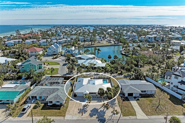 birds eye view of property with a water view and a residential view