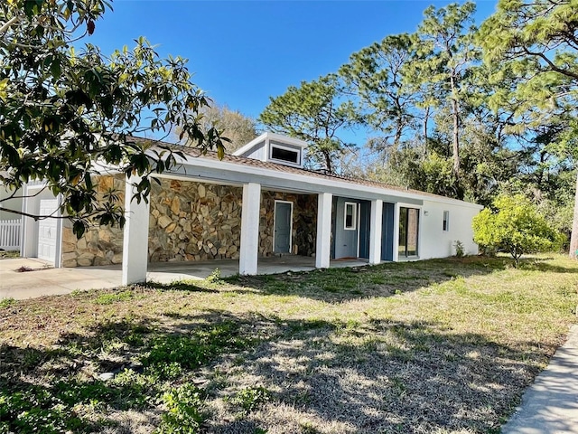 view of front of house with stone siding and a front lawn