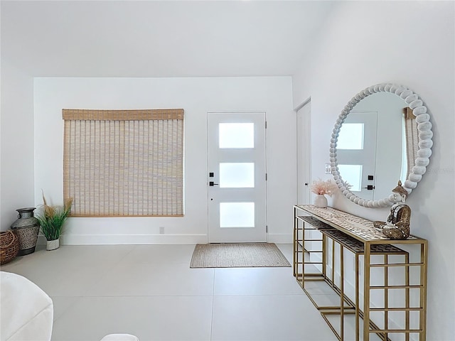 tiled foyer featuring baseboards