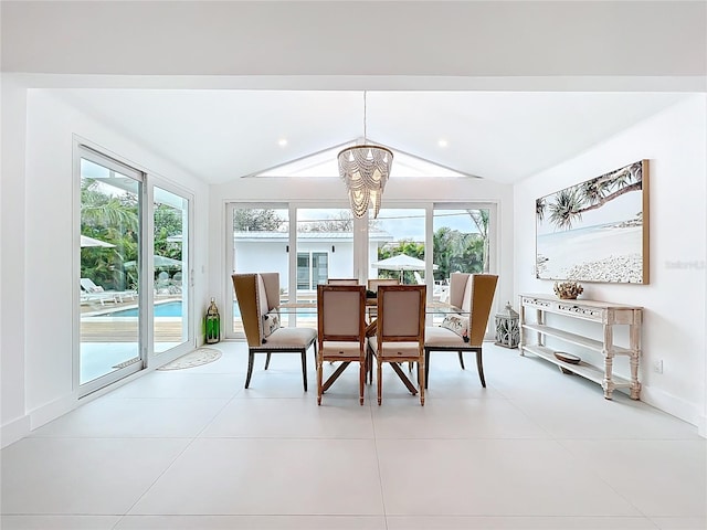 dining room featuring a chandelier, light tile patterned flooring, vaulted ceiling, and baseboards