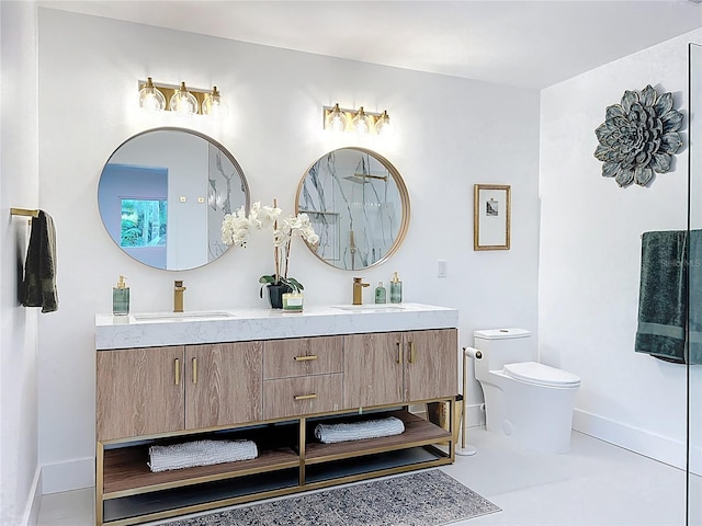 full bath with toilet, double vanity, baseboards, and a sink